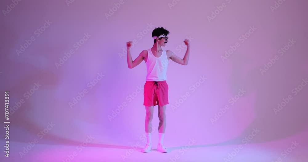 Immerse yourself in the charm of retro fitness as a cheerful Caucasian man, sporting a smile, confidently pumping biceps against a captivating purple background. Immerse yourself in the charm of retro fitness as a cheerful Caucasian man, sporting a smile, confidently pumping biceps against a captivating purple background.
