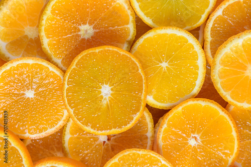 juicy tangerines cut into circles as a background 5