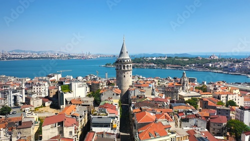 Beyoglu Region and Galata tower, one of the ancient symbols of Istanbul. Crowded city skyline and Bosphorus in the background. Aerial shot with a drone
