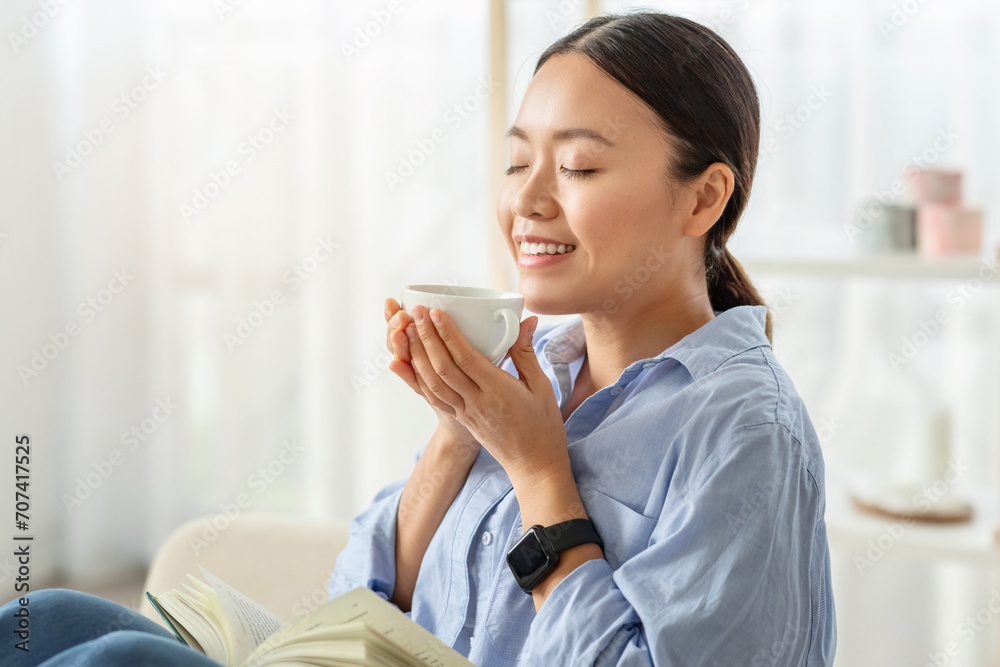 Portrait of peaceful asian woman enjoying aromatic coffee Portrait of peaceful asian woman enjoying aromatic coffee