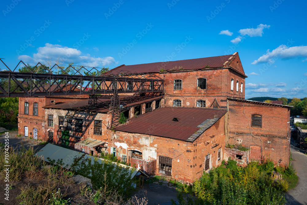 An old abandoned brick factory against a bright sky