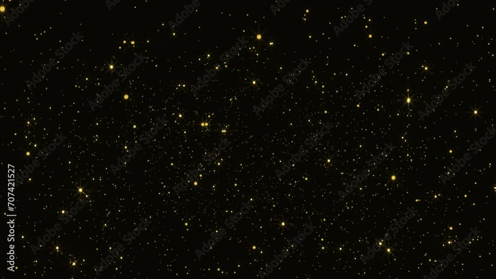 Gold dust particles fly in slow motion in the air lingering slowly ...