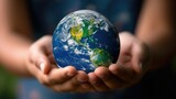 Close-up of two hands gently cradling a vibrant depiction of Earth, symbolizing care and responsibility for our planet