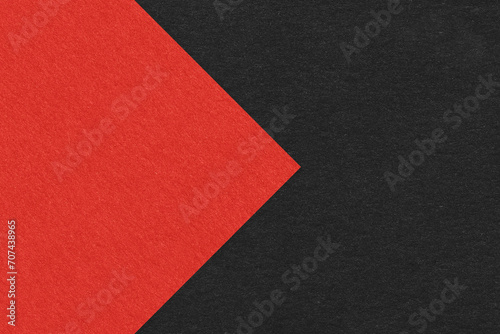 Texture of black paper background, half two colors with red arrow, macro. Structure of dense craft cardboard. stock photo