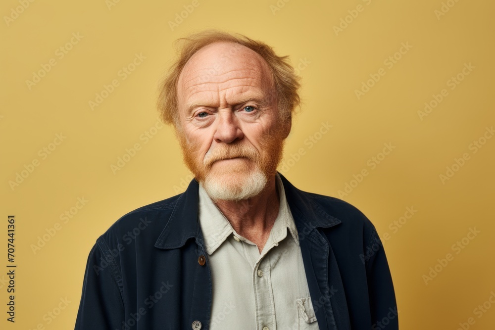 Portrait of an old man with a beard on a yellow background. Portrait of an old man with a beard on a yellow background.