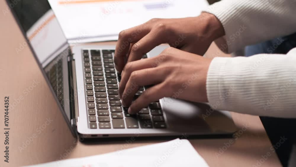 Detailed close up captures the hands of a man, skillfully typing on the laptop keyboard. The fluid movements and focused engagement with the device create a dynamic and productive scene. Detailed close up captures the hands of a man, skillfully typing on the laptop keyboard. The fluid movements and focused engagement with the device create a dynamic and productive scene.