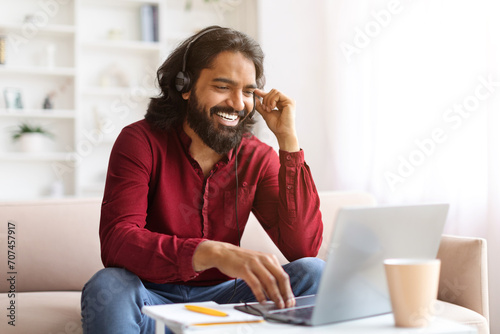 Indian man have online meeting with colleagues, working from home photo