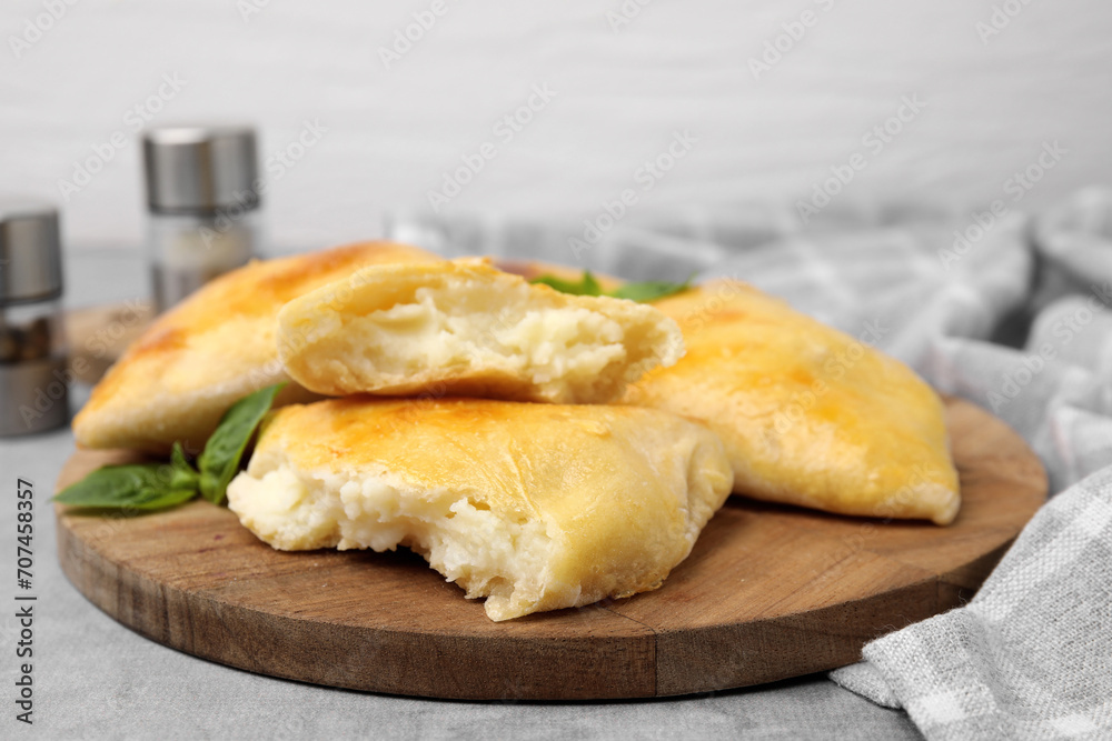 Delicious samosas and basil on grey table Delicious samosas and basil on grey table