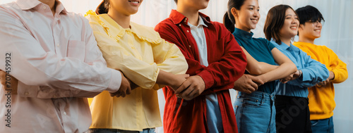 Panoramic banner young asian startup company employee wearing colorful casual wear stand in line and join hand together symbolize creative teamwork, job employment, HR agency recruitment. Synergic