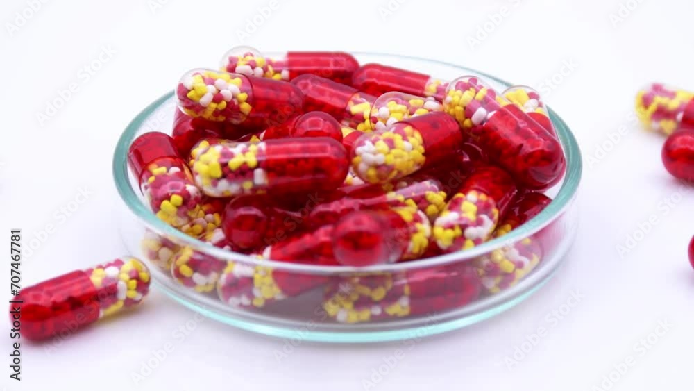 Pellets in transparent and red hard gelatin capsule on white background. Pellets in transparent and red hard gelatin capsule on white background.