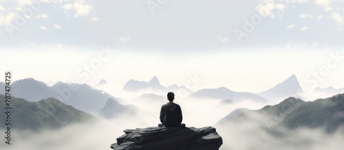 Meditation, landscape and man sitting on mountain top for mindfulness and spirituality. Peaceful, stress free and focus in nature with view, for mental health, zen and meditating practise. photo