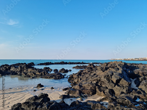 This is a Jeju seascape with basalt rocks. © binimin