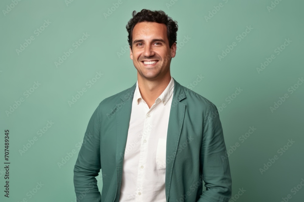Portrait of a handsome young man in a green jacket smiling at the camera Portrait of a handsome young man in a green jacket smiling at the camera