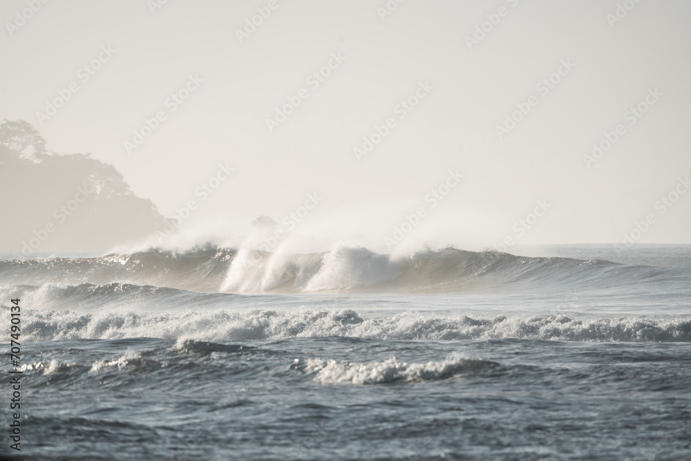Ocean view with big waves in the morning with beautiful fog in Dominical, Costa Rica surf header banner background pretty yoga peaceful mindful relax