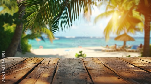 Empty wooden table and palm leaves with party on beach blurred background 