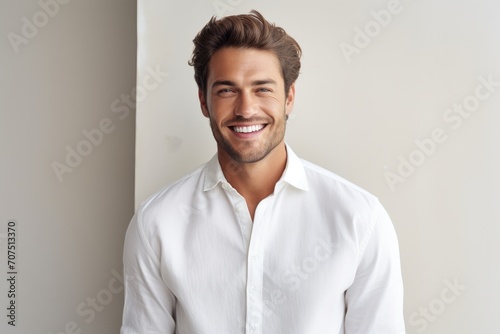 Smiling Man Leaning Against Wall in White Shirt © pham