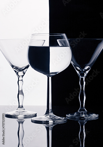 Three wine glasses isolated on black and white splited background