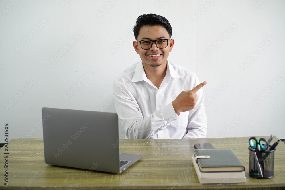 young asian businessman in a workplace pointing to the side to present a product wear white shirt isolated white background young asian businessman in a workplace pointing to the side to present a product wear white shirt isolated white background