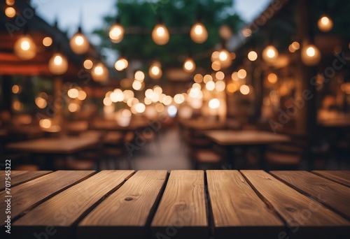 Empty wooden table and bokeh lights blurred outdoor cafe background High quality photo
