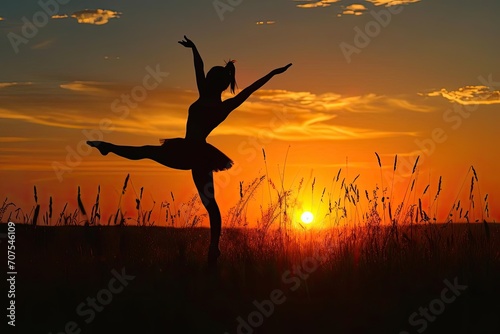 Silhouette of a young dancer practicing at sunset