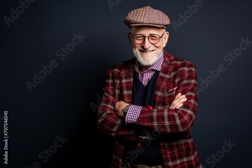 Portrait of a happy senior man wearing a plaid shirt and a cap.