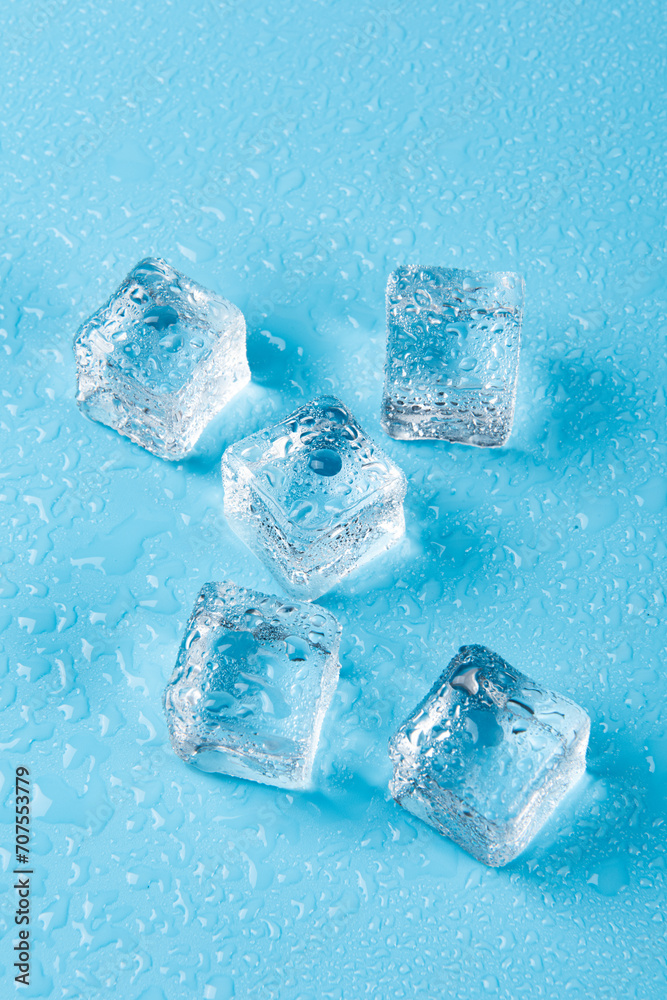 Ice cubes with water drops on a blue background. Ice cubes with water drops on a blue background.