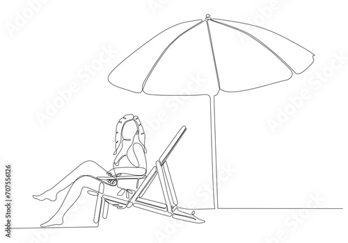 continuous line drawing of woman relaxing and sitting on deck chair by the beach isolated on white background