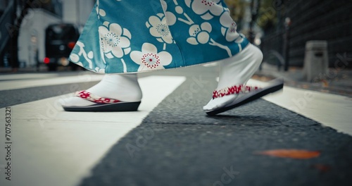 Japanese woman, feet and walking in kimono in city, journey and wellness for heritage by outdoor. Person, steps and traditional clothes in tokyo for holiday and pedestrian crossing in japan fashion photo