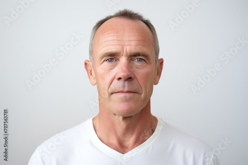 Portrait of mature man looking at camera. Isolated on white background.