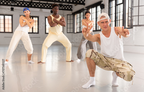 People practicing hip-hop movements in dancing class