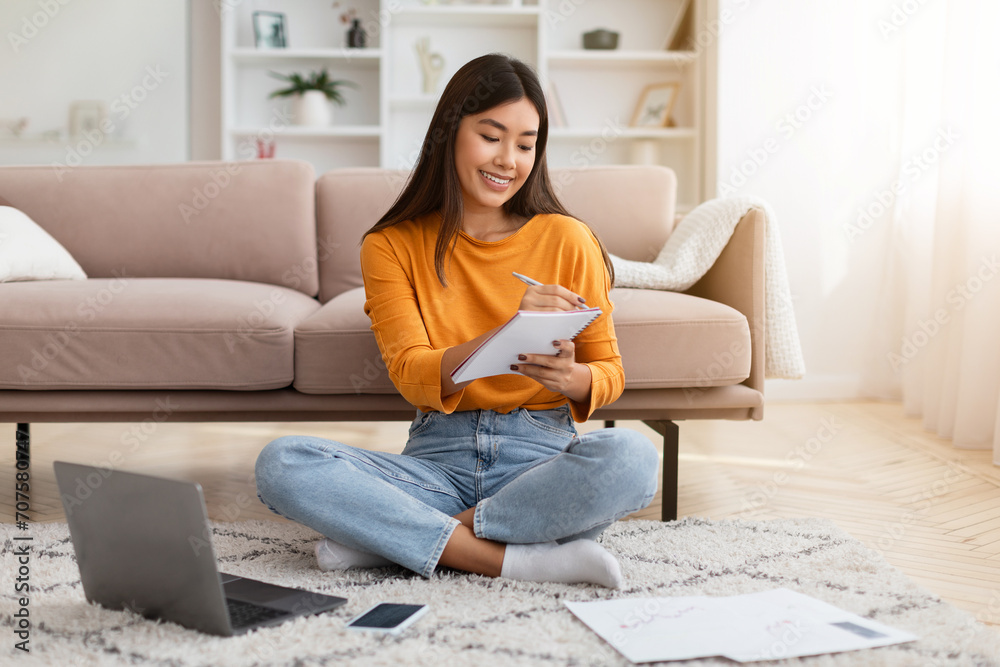 Happy millennial asian woman studying at home Happy millennial asian woman studying at home