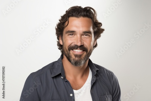 Portrait of handsome man with beard and mustache smiling at camera. © Inigo