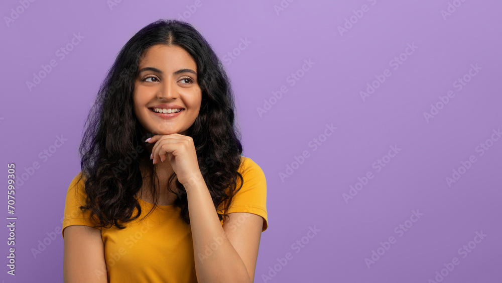 Curious young eastern woman looking at copy space Curious young eastern woman looking at copy space