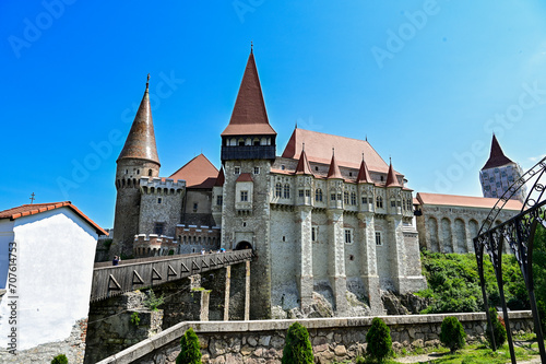 The famous Hunedoara Castle, Castelul Corvinilor or Corvin Castle with the Podul de Lemn castle bridge in summer with a blue sky, Hunedoara, Transylvania, Romania photo