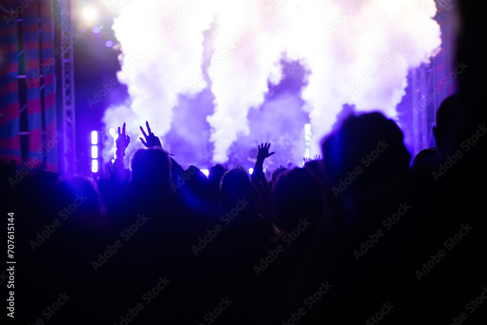 Abstract photo of crowd at concert and blurred stage lights.