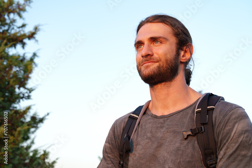 Portrait of hiker man with backpack trekking in the mountains