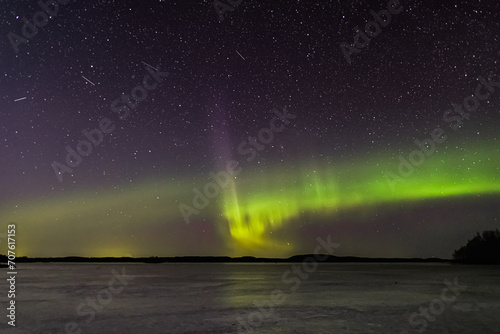 auroras and stars over the frozen lake