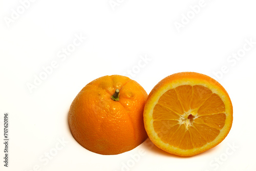 closeup of a fresh orange cut in half isolated on white background and copy space