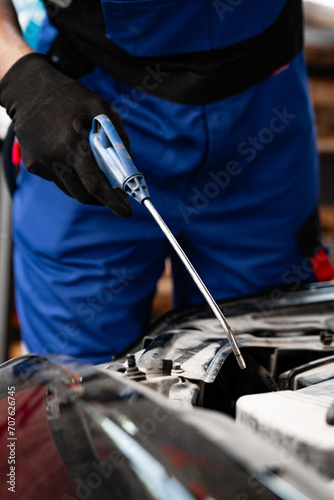 Close up of hands of auto mechanic working in a garage
