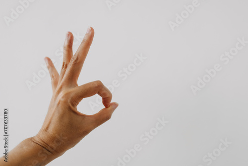 Photo of woman's hand showing numbers three, counting fingers ok good gesture, isolated on white background wall. photo