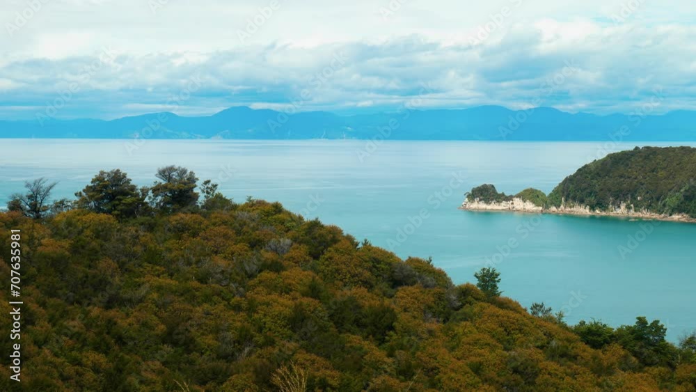 Abel Tasman: Island beauty with a distant peninsula. Mesmerizing stock footage capturing coastal serenity. Abel Tasman: Island beauty with a distant peninsula. Mesmerizing stock footage capturing coastal serenity.