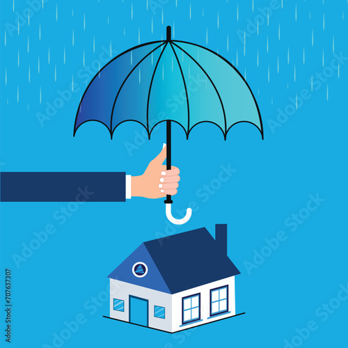 Hand holding an umbrella protecting house