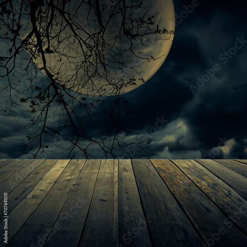 Old wooden table over dead tree, Halloween background