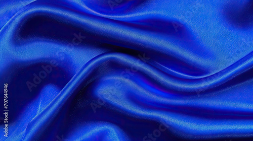 Abstract dark blue background. navy blue fabric texture background. dark blue silk satin. Curtain. Luxury background for design. Shiny fabric. Wavy folds. 