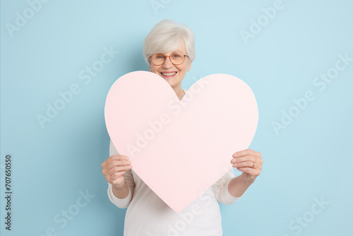 elderly woman holding a heart