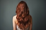 Viewed from the rear, long auburn hair flows in natural waves. Generative Ai.