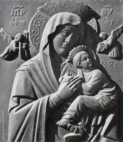 A cast-iron bas-relief of the Mother of God's unceasing help. Scene of Blessed Saint Mary holding the child Jesus.