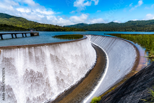 Water uniformly flowing down in the beautiful dam in nearly perfect weather