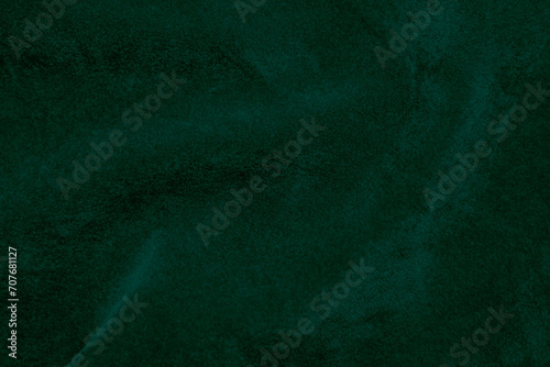 Dark green velvet fabric texture used as background. Emerald color panne fabric background of soft and smooth textile material. crushed velvet .luxury emerald tone for silk...