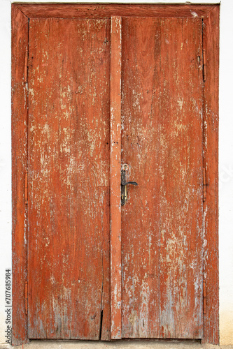 Wooden boards closed doors with brown peeling paint, abstract texture background © Dorin